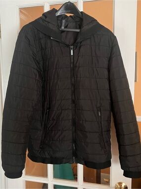 black Zara Man quilted puffer jacket with a front zipper, attached hood/pockets
